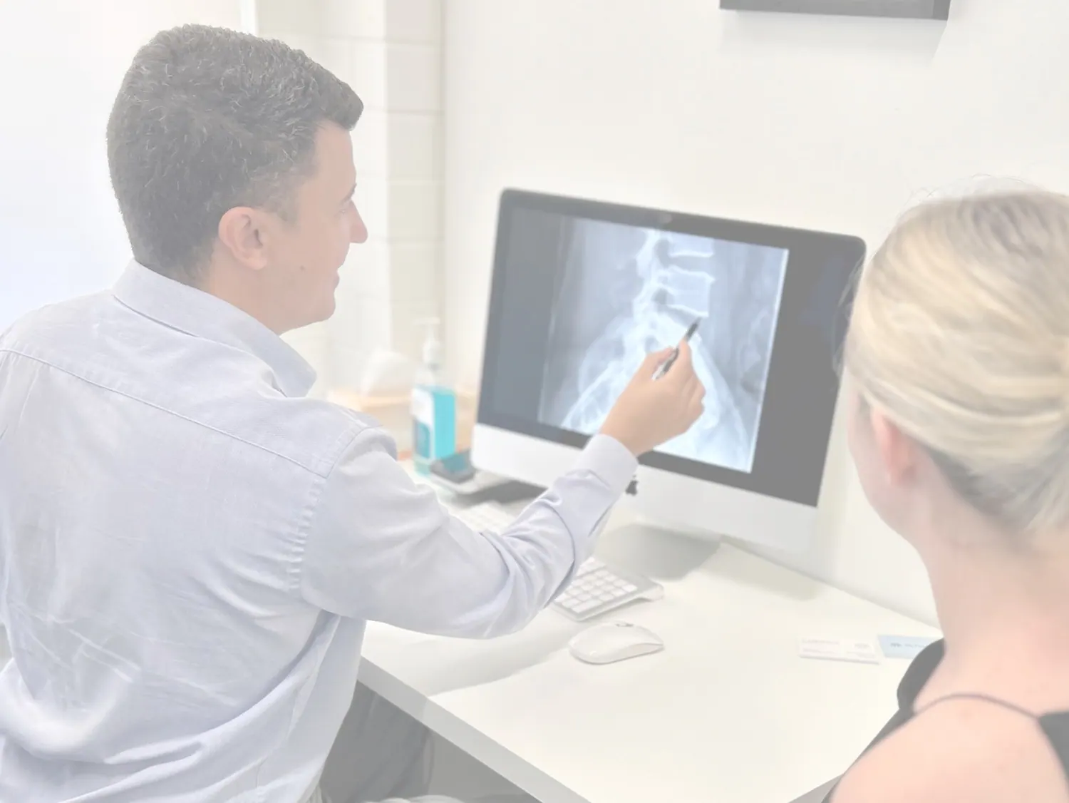 Dr Luke discussing findings with a patient